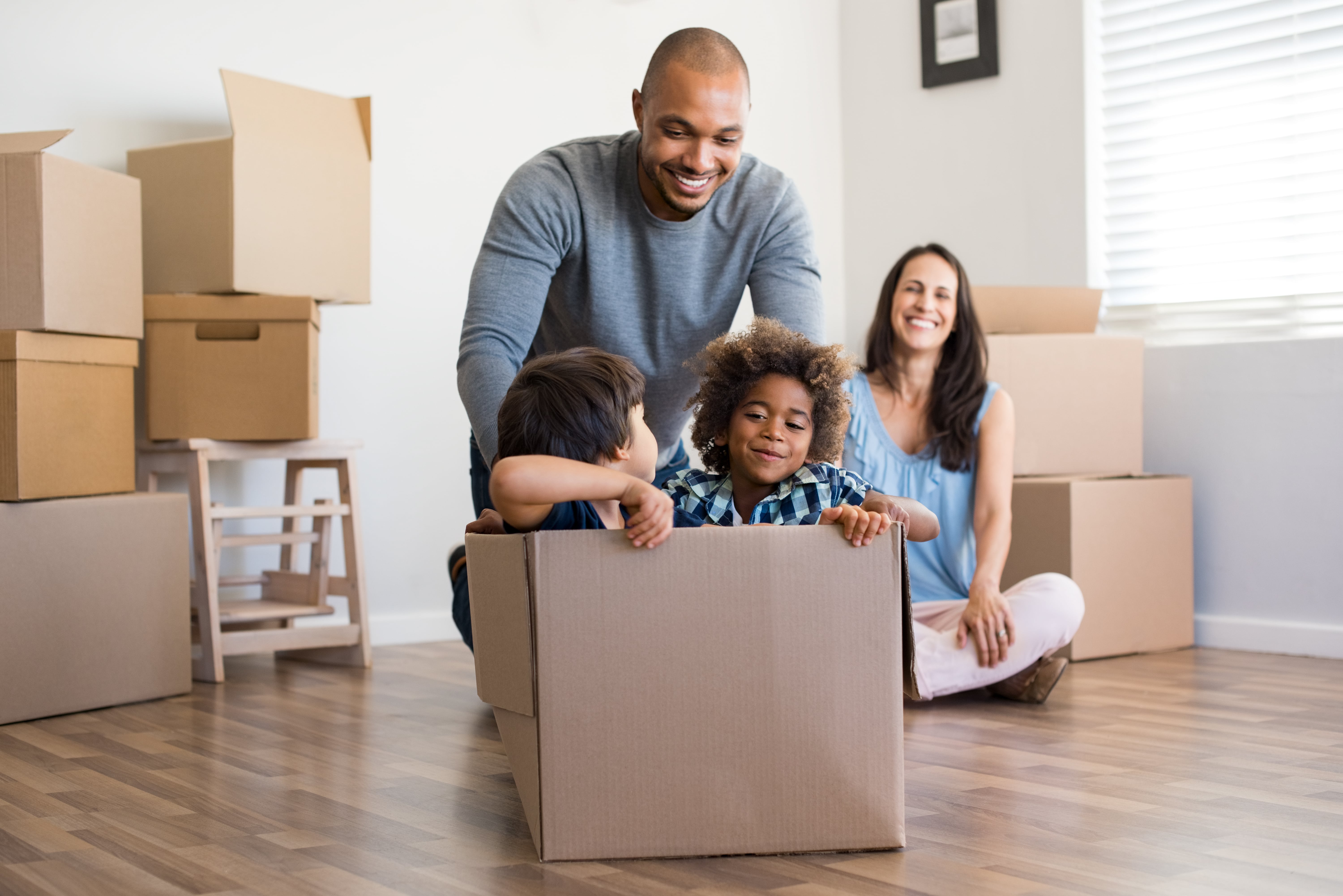 Family Packing Boxes Ready To Move